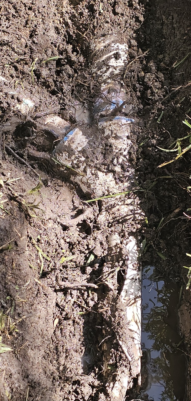 Excavated damaged underground yard drain pipe